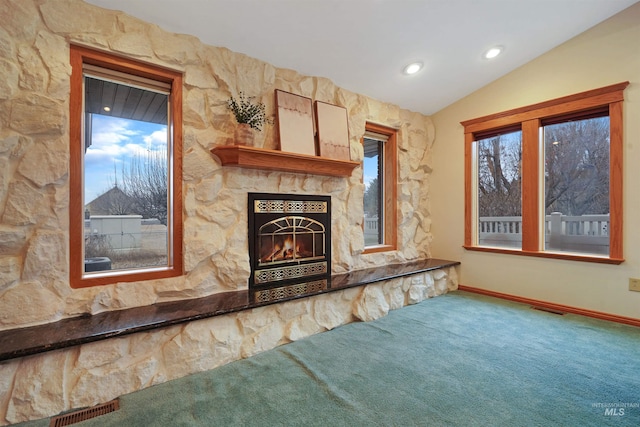 435 W 24th St, Burley, ID 83318 - unfurnished living room with lofted ceiling, carpet floors, and a stone fireplace