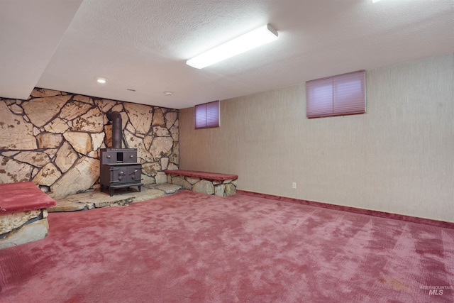435 W 24th St, Burley, ID 83318 - basement with carpet flooring, a wood stove, and a textured ceiling