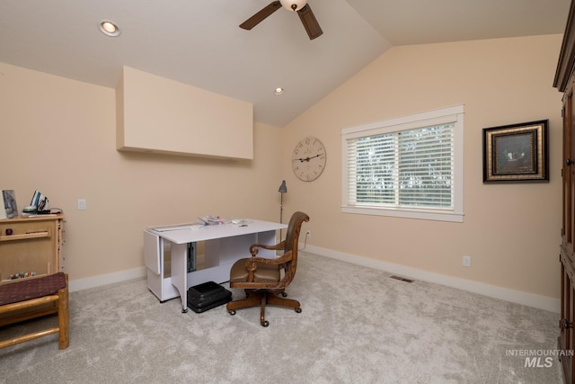 home office with visible vents, a ceiling fan, lofted ceiling, and light colored carpet