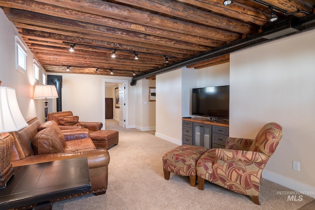 carpeted living room with track lighting, baseboards, and bar