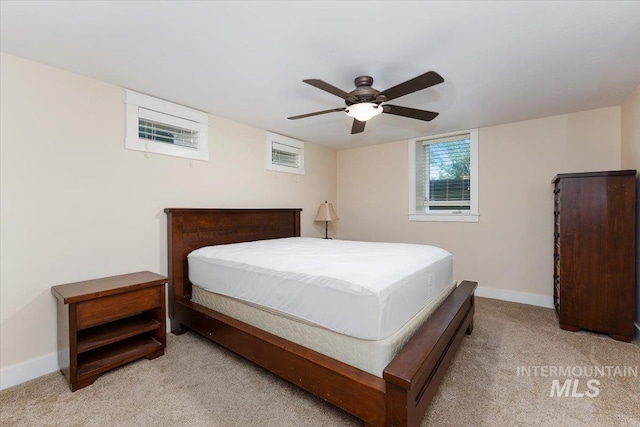 bedroom with baseboards, light carpet, and ceiling fan