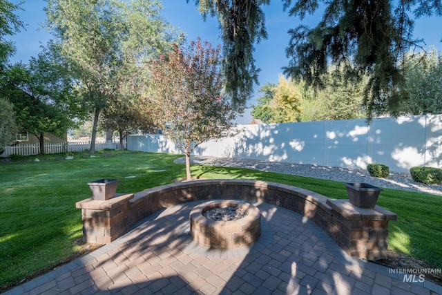 view of patio / terrace with a fenced backyard and a fire pit