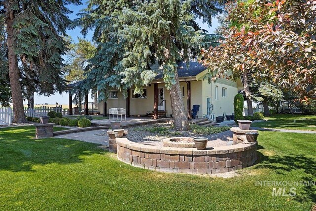 3350 E 4000 N, Twin Falls, ID 83301 - view of front of home featuring stucco siding, fence, a front yard, and a patio