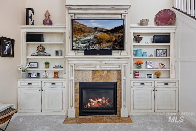 carpeted living room featuring a tile fireplace