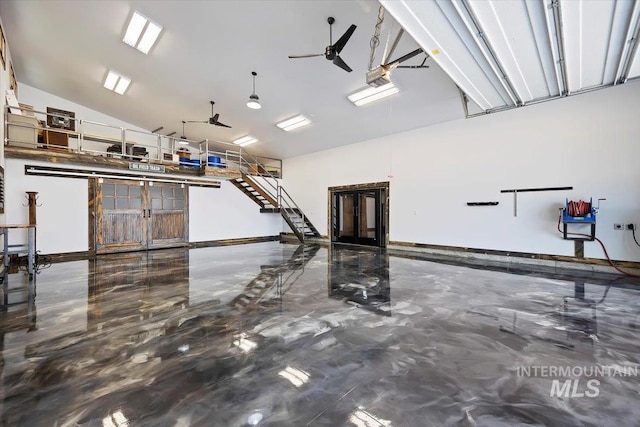 garage with baseboards and a garage door opener