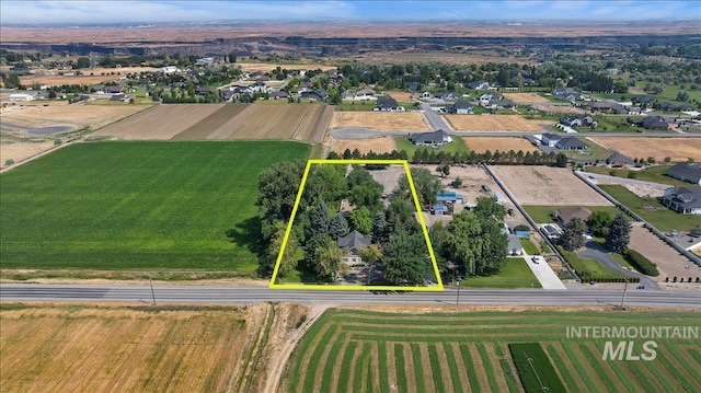 drone / aerial view featuring a residential view and a rural view