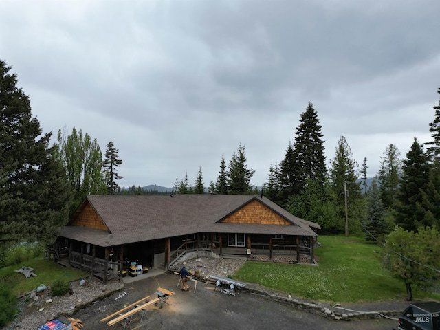 14797 Grangemont Rd, Orofino, ID 83544 - view of front of home featuring a front yard, roof with shingles, and a forest view