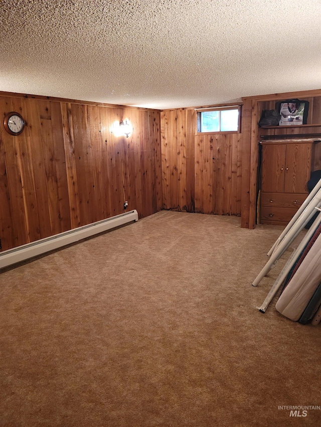 14797 Grangemont Rd, Orofino, ID 83544 - basement featuring a baseboard radiator, a textured ceiling, wooden walls, and carpet flooring