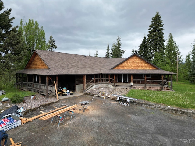 14797 Grangemont Rd, Orofino, ID 83544 - view of front of home featuring a porch, roof with shingles, and a front yard