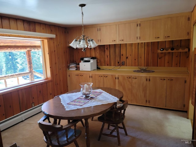 14797 Grangemont Rd, Orofino, ID 83544 - dining space with baseboard heating, a chandelier, and wood walls