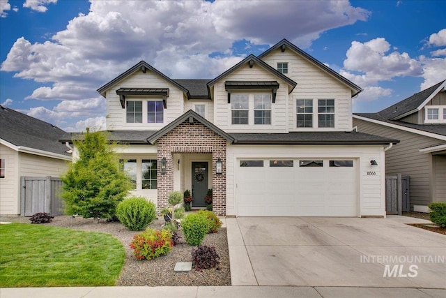 view of front of property with fence, concrete driveway, a garage, and brick siding