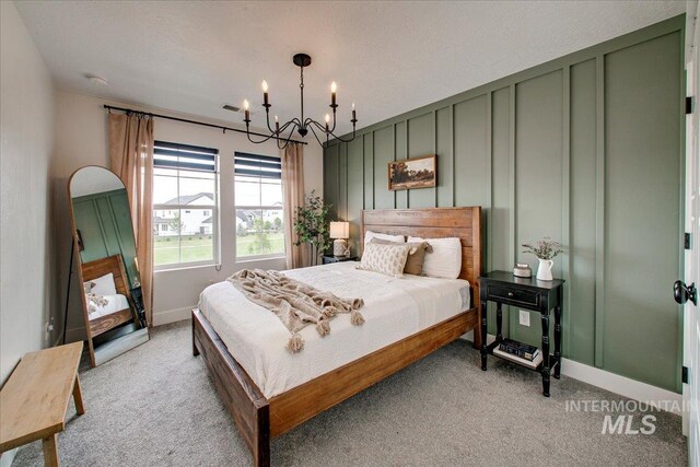 bedroom with light carpet, a chandelier, and baseboards