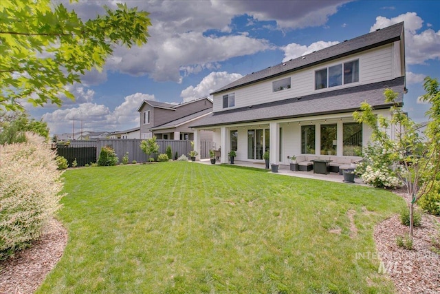 back of property with an outdoor living space and a patio area