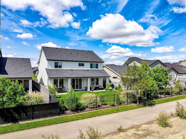 view of front of property with a patio area and a fenced backyard