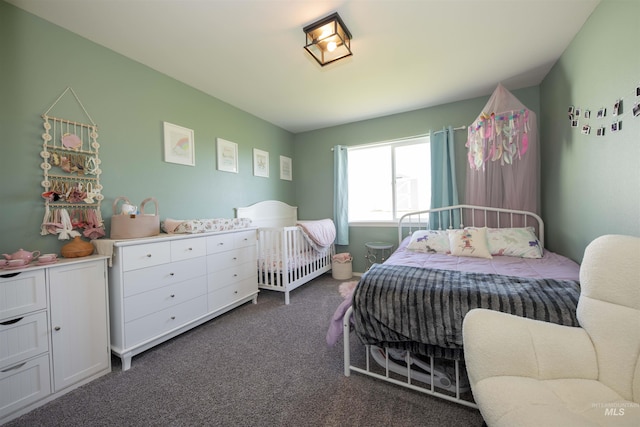 bedroom featuring dark colored carpet