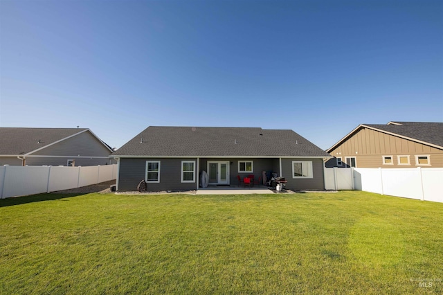 back of house featuring a yard, a fenced backyard, and a patio