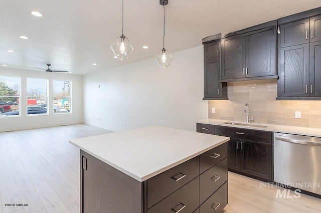 1327 N Webb Way, Meridian, ID 83642 - kitchen with dishwasher, a sink, backsplash, light wood-style floors, and light countertops
