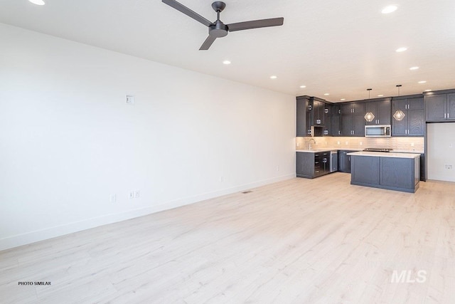 1327 N Webb Way, Meridian, ID 83642 - unfurnished living room featuring recessed lighting, light wood-style floors, a ceiling fan, baseboards, and a sink