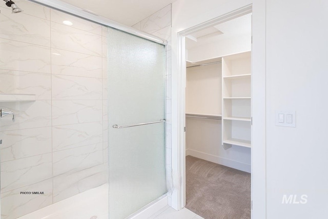1327 N Webb Way, Meridian, ID 83642 - full bathroom featuring a stall shower, a spacious closet, and baseboards