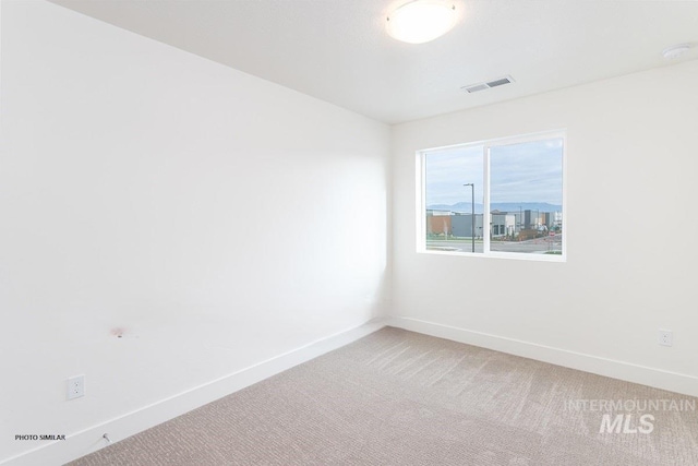1327 N Webb Way, Meridian, ID 83642 - spare room with light colored carpet, baseboards, and a smoke detector