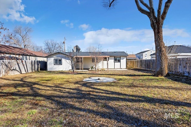 back of house featuring a yard