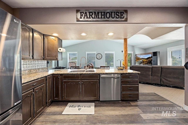 2123 E 3970 N, Filer, ID 83328 - kitchen with appliances with stainless steel finishes, a sink, dark brown cabinets, lofted ceiling, and a peninsula