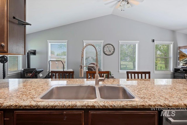 2123 E 3970 N, Filer, ID 83328 - kitchen with a sink, dark brown cabinets, vaulted ceiling, and a wood stove