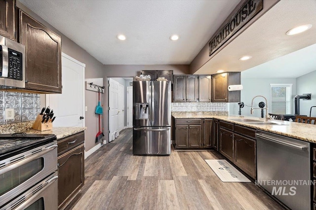 2123 E 3970 N, Filer, ID 83328 - kitchen featuring appliances with stainless steel finishes, a sink, wood finished floors, backsplash, and recessed lighting