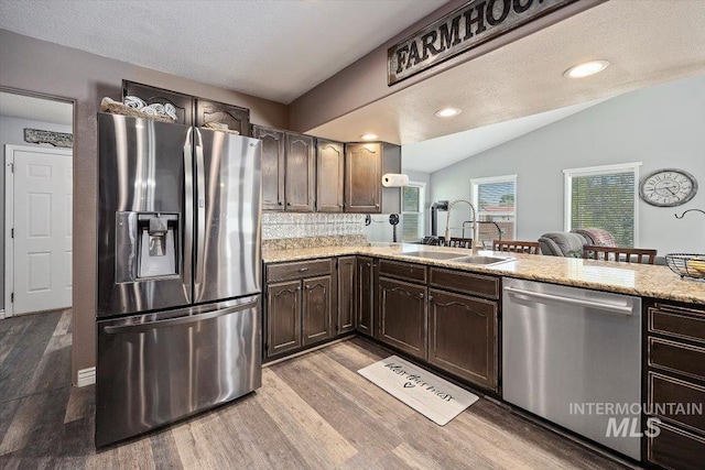 2123 E 3970 N, Filer, ID 83328 - kitchen with stainless steel appliances, a sink, light wood-style floors, lofted ceiling, and dark brown cabinets