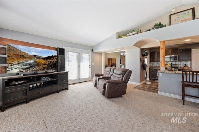 2123 E 3970 N, Filer, ID 83328 - living area with light carpet, lofted ceiling, baseboards, and arched walkways