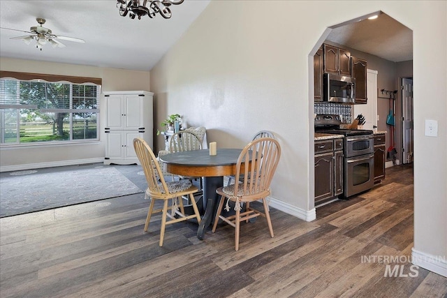 2123 E 3970 N, Filer, ID 83328 - dining area featuring dark wood finished floors, baseboards, ceiling fan, vaulted ceiling, and arched walkways