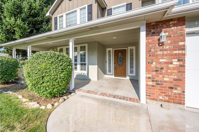 property entrance with covered porch