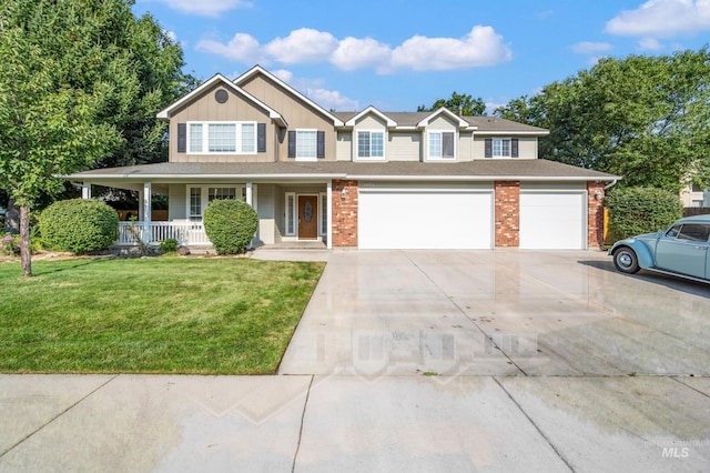 view of front facade featuring a front yard, a garage, and a porch