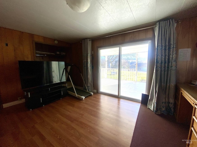 living room with wooden walls and dark wood-type flooring