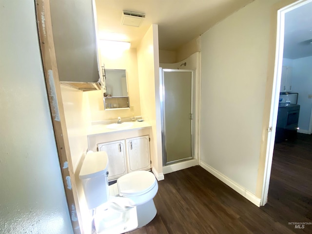 bathroom with vanity, hardwood / wood-style flooring, toilet, and walk in shower