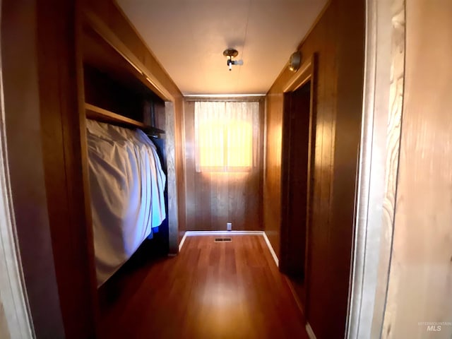 interior space with wood walls and dark hardwood / wood-style flooring