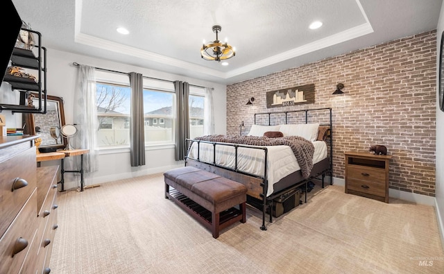 bedroom with a tray ceiling, a notable chandelier, and a textured ceiling