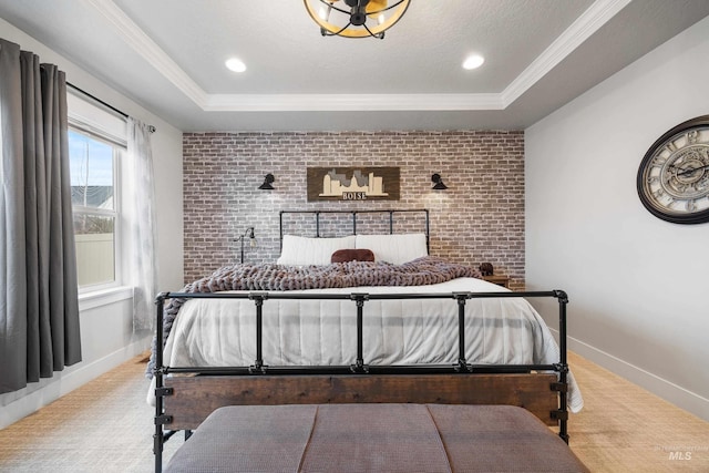 carpeted bedroom featuring baseboards, brick wall, a tray ceiling, ornamental molding, and a textured ceiling