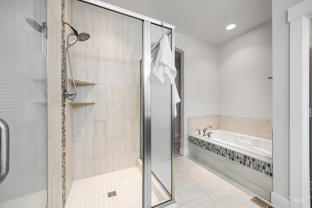 full bathroom with tile patterned floors, a bath, and a shower stall