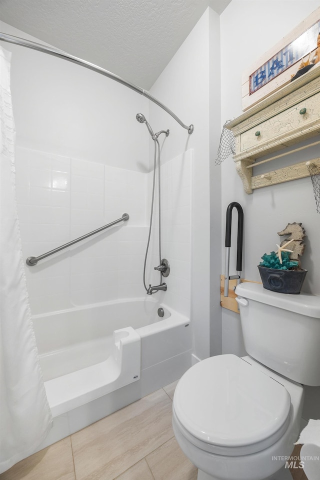 bathroom featuring shower / bath combination with curtain, toilet, and a textured ceiling