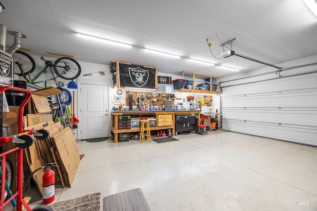 garage featuring a workshop area and a garage door opener