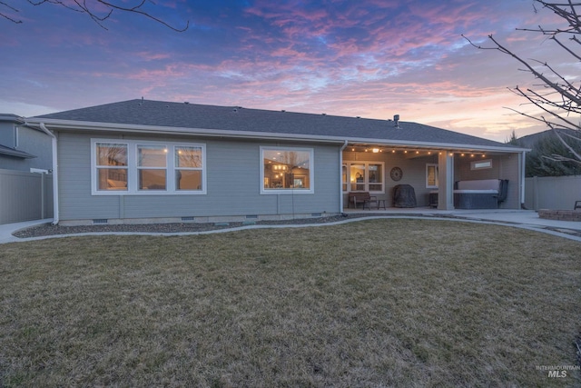 view of front facade with a patio, fence, a front yard, and crawl space