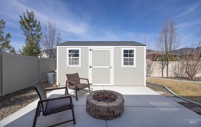 view of shed with a fire pit and a fenced backyard