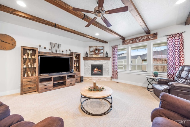 living area with a textured ceiling, baseboards, carpet floors, and ceiling fan