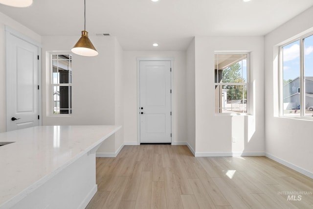 entryway featuring light wood-type flooring, visible vents, baseboards, and recessed lighting