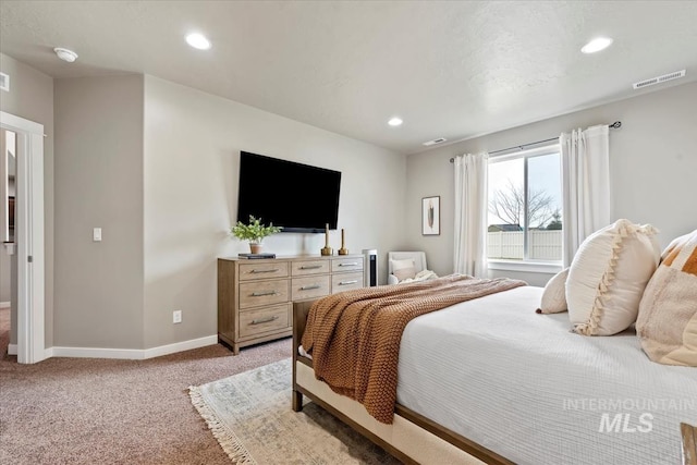 bedroom with recessed lighting, light colored carpet, visible vents, and baseboards