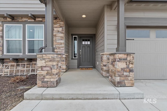 property entrance featuring stone siding and a porch