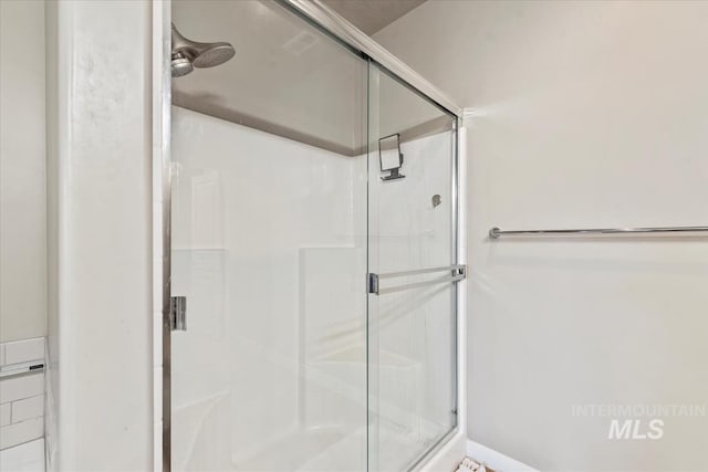 full bath featuring a shower stall