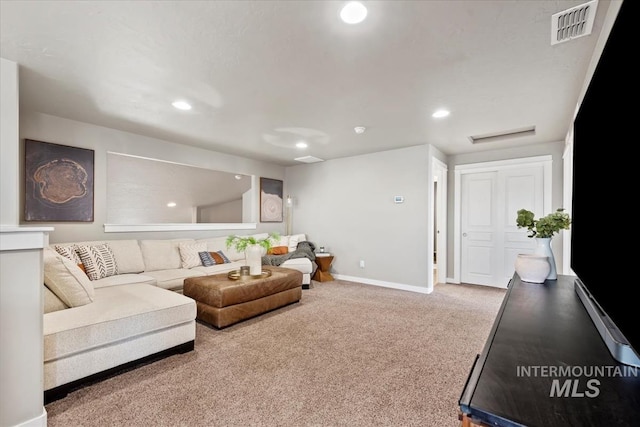 carpeted living area featuring recessed lighting, visible vents, and baseboards