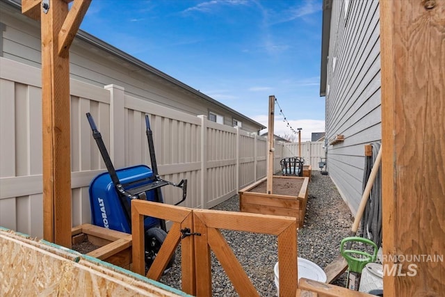 view of yard featuring a fenced backyard and a vegetable garden